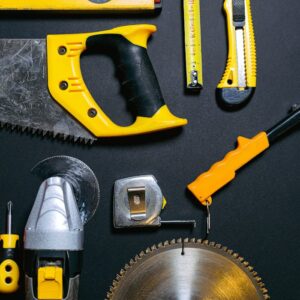 A collection of yellow and black construction tools arranged on a dark flat surface, ideal for DIY projects.